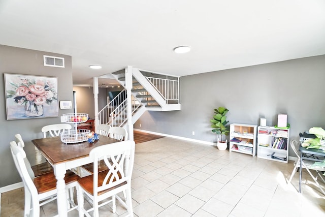 dining area with light tile patterned floors