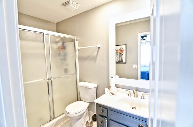 bathroom featuring walk in shower, vanity, and toilet