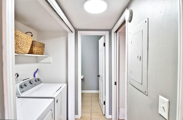 laundry area with washer and dryer, light tile patterned floors, and electric panel