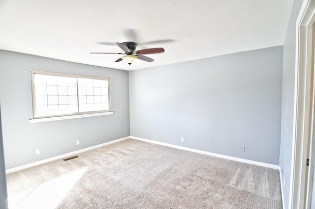 spare room featuring ceiling fan and carpet flooring