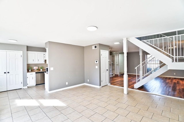 unfurnished living room featuring light tile patterned floors