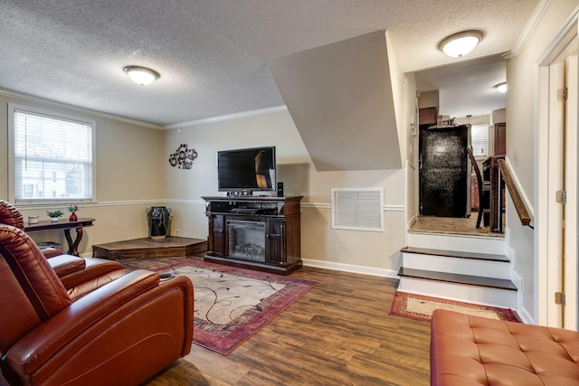 living room featuring ornamental molding, a textured ceiling, and dark hardwood / wood-style floors