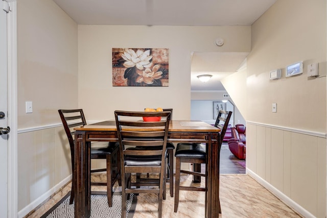 dining room with wood walls