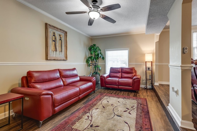 living room featuring ornamental molding, ceiling fan, a textured ceiling, and dark hardwood / wood-style floors