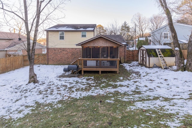 snow covered house with a sunroom