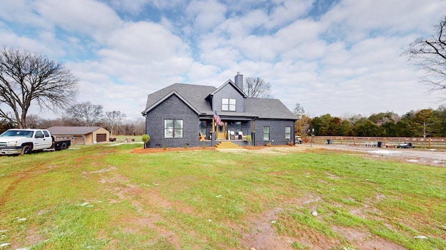 view of front of home with a garage, covered porch, and a front lawn