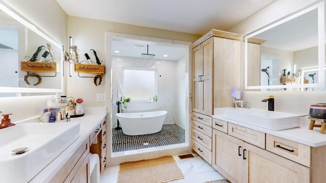 bathroom featuring vanity and independent shower and bath