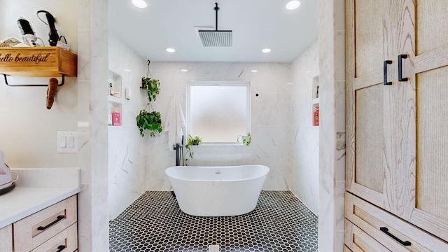 bathroom featuring tile walls, separate shower and tub, and vanity