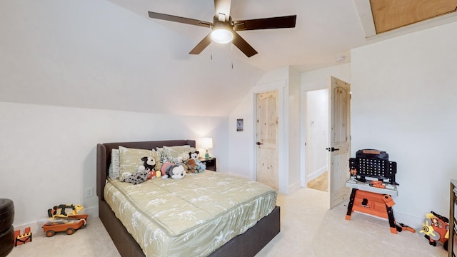 carpeted bedroom with ceiling fan and vaulted ceiling