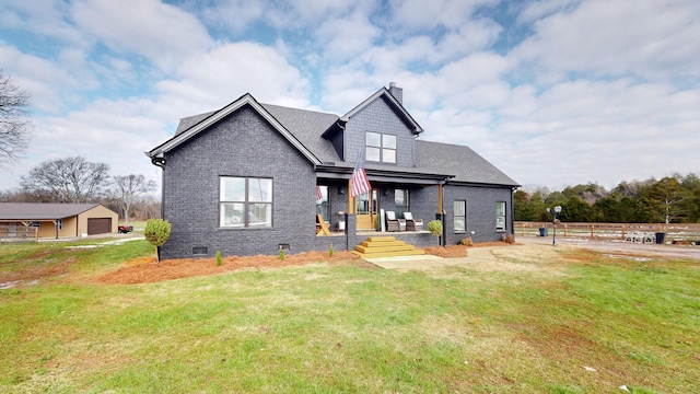 view of front of house featuring a porch, a front yard, and a garage