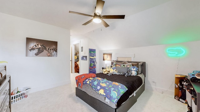 carpeted bedroom with ceiling fan and vaulted ceiling