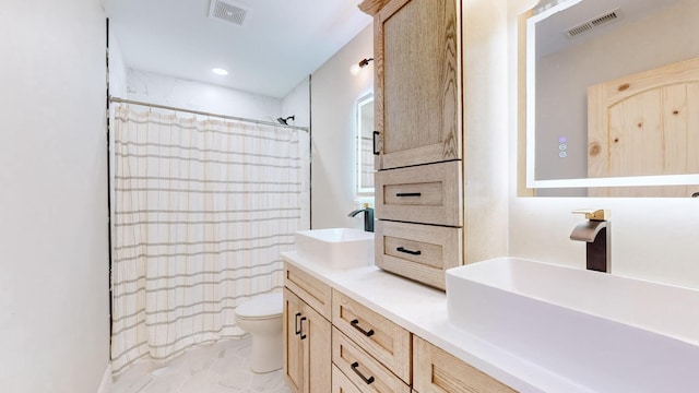 bathroom with toilet, walk in shower, and vanity