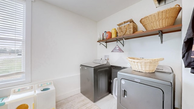 washroom with washing machine and clothes dryer