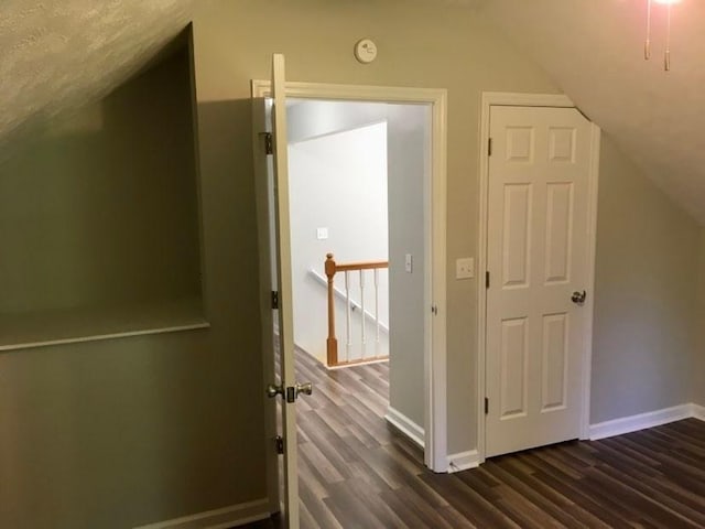 bonus room with lofted ceiling and dark wood-type flooring