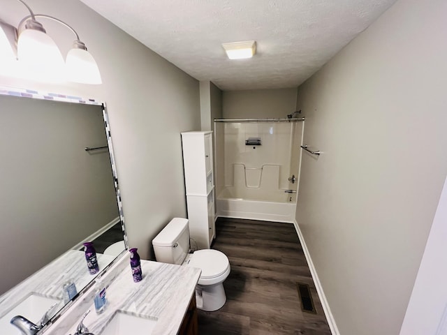 306 Turkey Creek Hwy, Carthage, TN 37030 - full bathroom with toilet,  shower combination, a textured ceiling, vanity, and hardwood / wood-style flooring