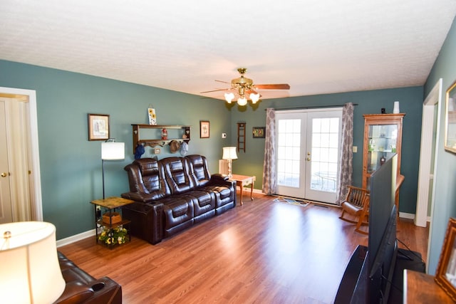 living room featuring french doors, wood-type flooring, and ceiling fan