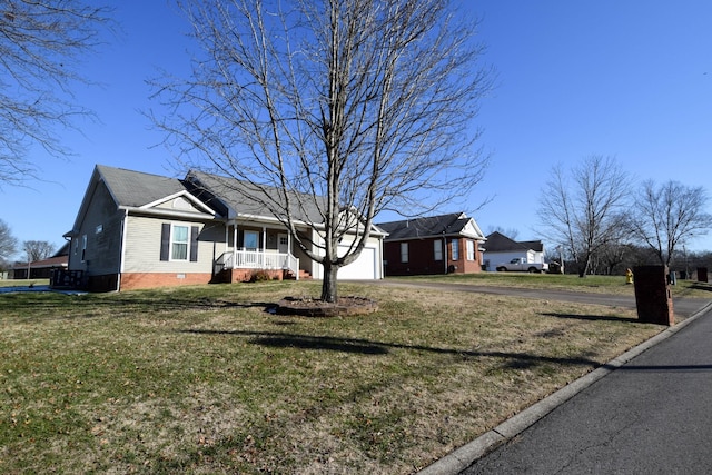 ranch-style house featuring covered porch, a front lawn, and a garage