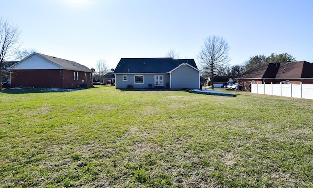 rear view of house featuring a yard