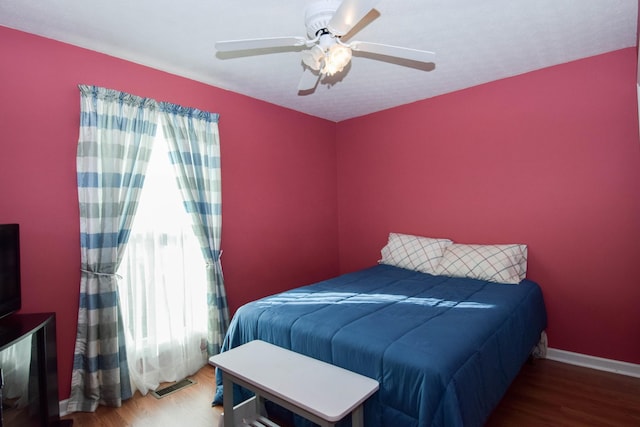 bedroom featuring ceiling fan and hardwood / wood-style flooring