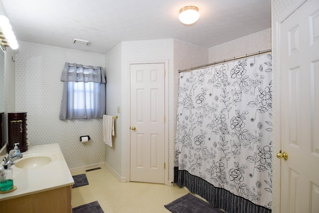 bathroom with shower / tub combo and vanity