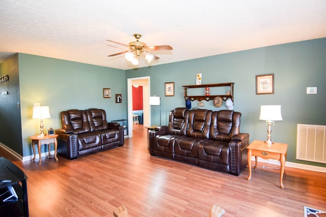 living room with ceiling fan and light wood-type flooring