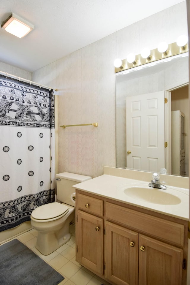 bathroom featuring toilet, tile patterned floors, a shower with shower curtain, and vanity