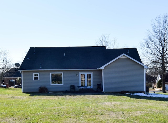 rear view of house with french doors and a yard