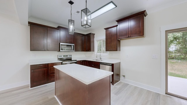 kitchen with a center island, a healthy amount of sunlight, hanging light fixtures, and appliances with stainless steel finishes