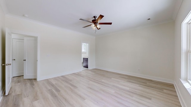 empty room with ceiling fan, ornamental molding, and light hardwood / wood-style flooring