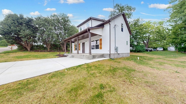 view of home's exterior with a yard and covered porch