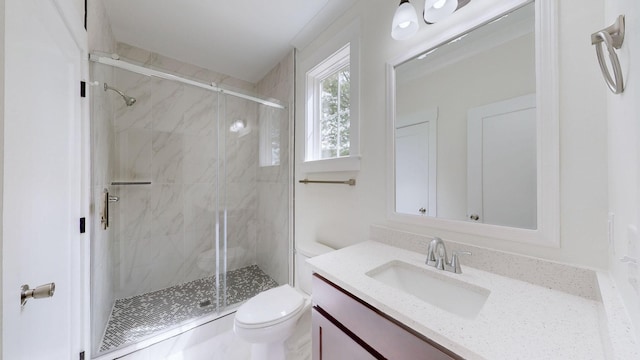 bathroom with toilet, a shower with door, and vanity