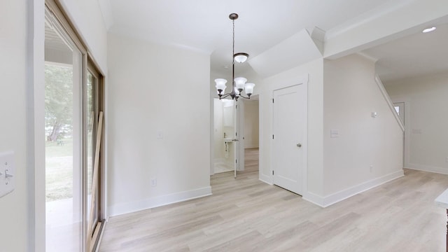 unfurnished dining area with a notable chandelier, light hardwood / wood-style flooring, and a healthy amount of sunlight