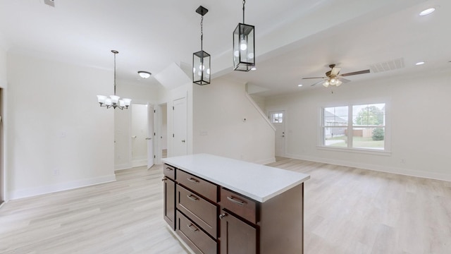 kitchen with ceiling fan with notable chandelier, decorative light fixtures, light hardwood / wood-style flooring, and dark brown cabinets