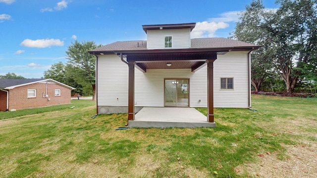 rear view of property with a patio and a yard