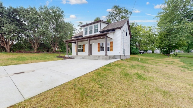 view of front facade with a front yard and a porch