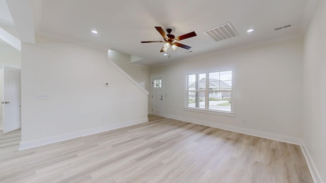 empty room featuring light wood-type flooring, ceiling fan, and crown molding