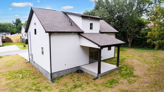 rear view of house featuring a patio and a lawn