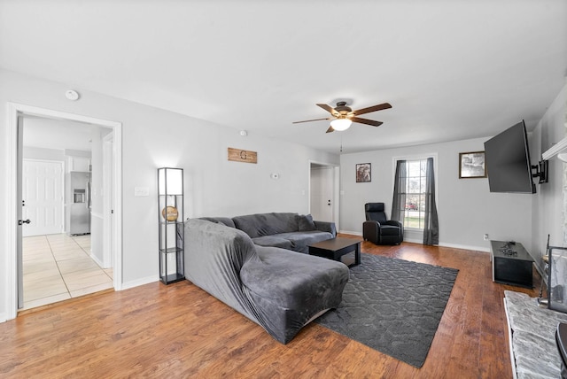 living room with ceiling fan and hardwood / wood-style floors