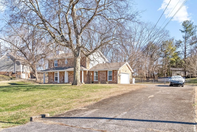 view of front facade with a front yard and a garage