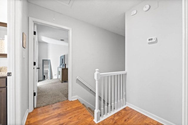 hallway with hardwood / wood-style flooring