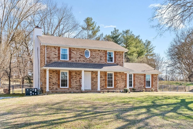 view of front of house featuring a front yard and central air condition unit