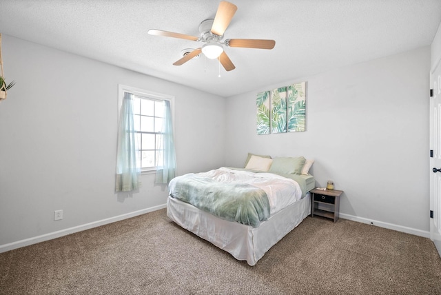 bedroom with a textured ceiling, ceiling fan, and carpet floors