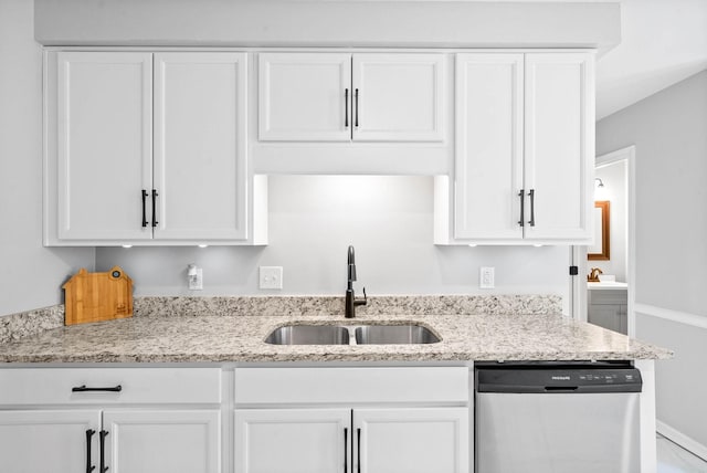 kitchen with dishwasher, white cabinets, light stone counters, and sink