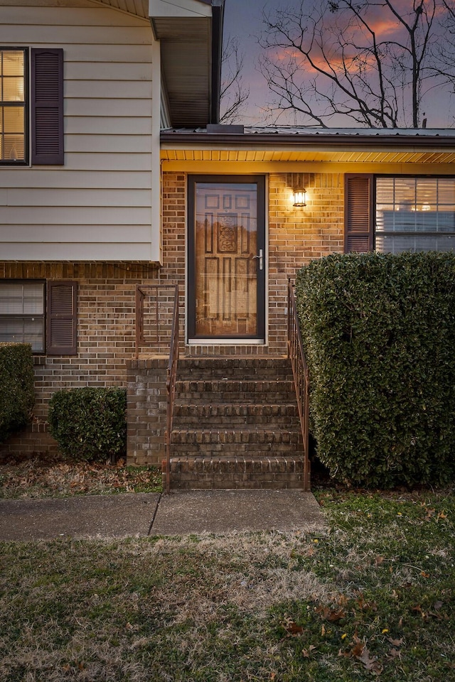 view of exterior entry at dusk