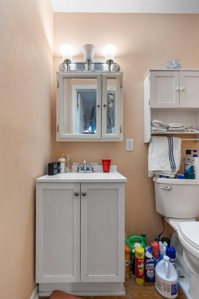 bathroom featuring toilet and vanity