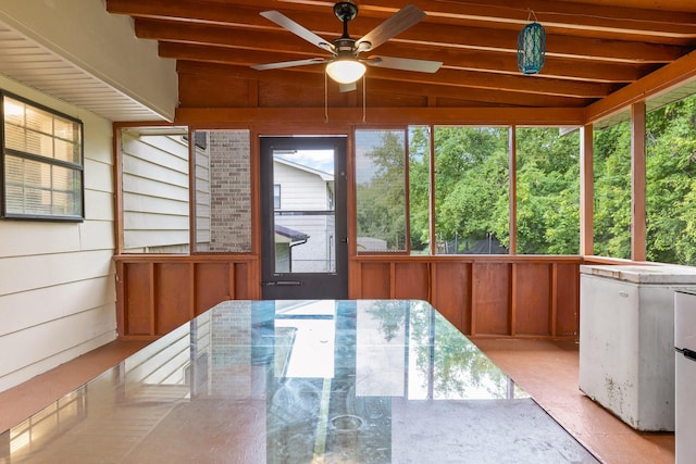 sunroom featuring ceiling fan, plenty of natural light, and lofted ceiling with beams