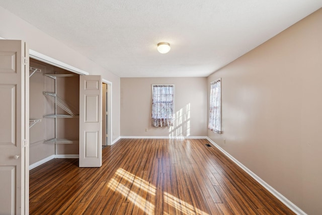 spare room featuring dark wood-type flooring