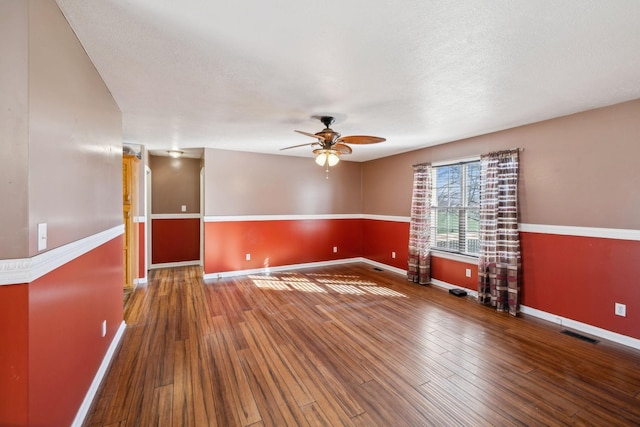 spare room with ceiling fan and hardwood / wood-style flooring