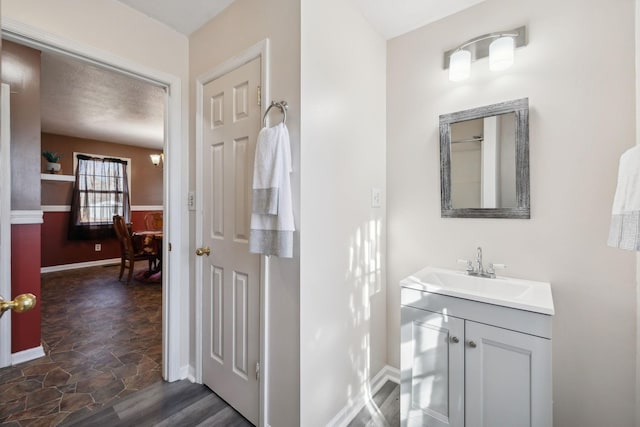 bathroom with a textured ceiling and vanity