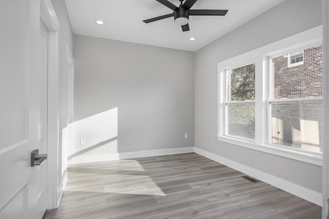 unfurnished room with light hardwood / wood-style floors, ceiling fan, and plenty of natural light